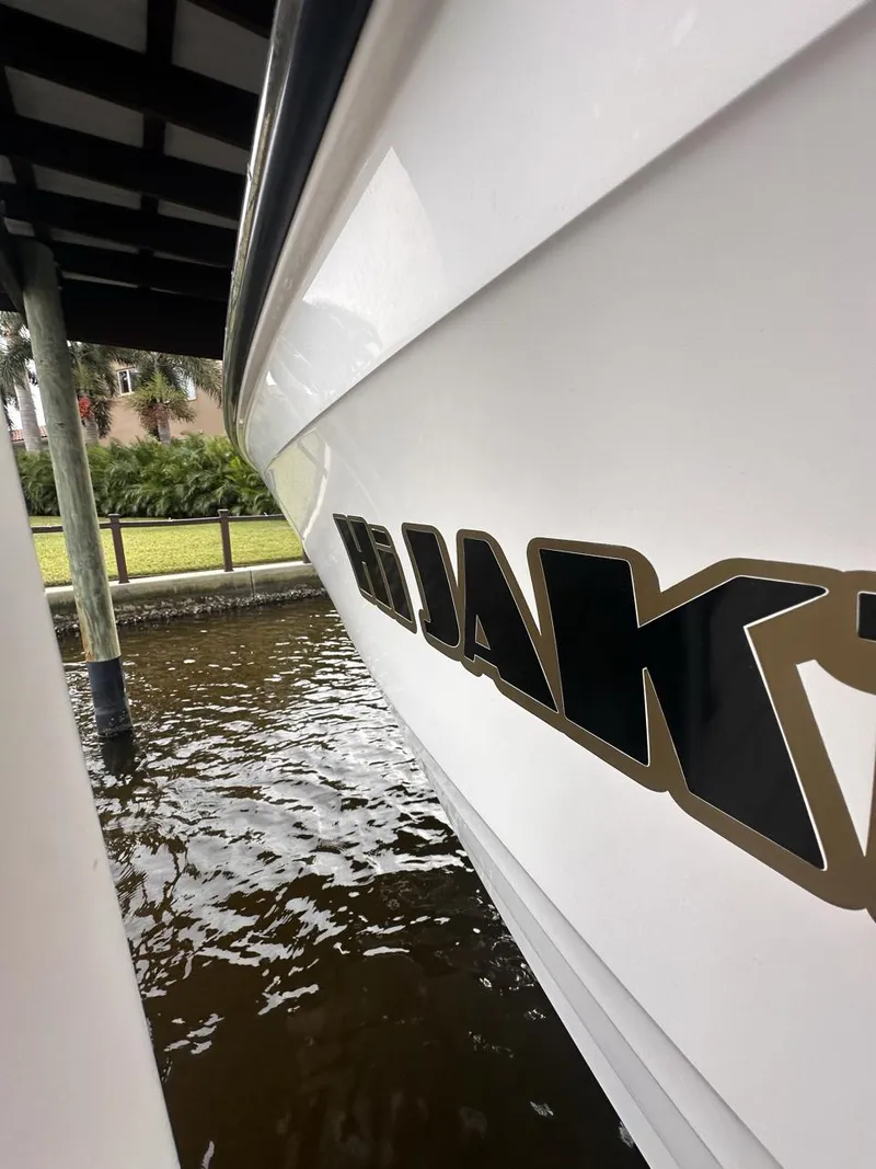 Slide: The Image of 2019 Sea Ray SPX 230 OB boat docked by water. - 41