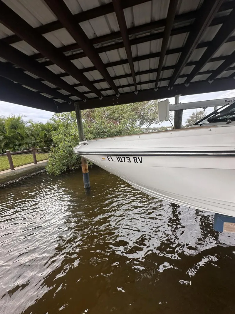 Slide: The Image of 2019 Sea Ray SPX 230 OB boat docked under shelter. - 44