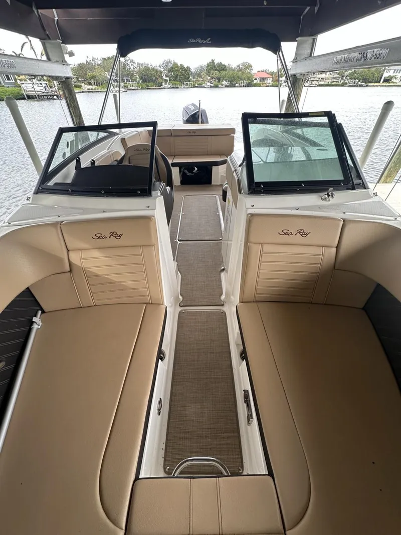 Slide: The Image of 2019 Sea Ray SPX 230 OB boat interior with tan seating and open deck layout. - 7