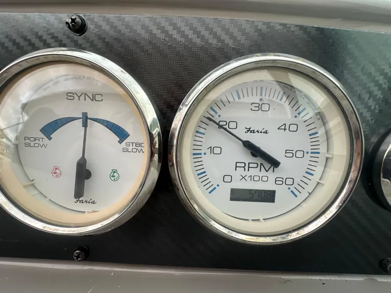 Slide: The Image of Close-up of 2001 Wellcraft 3300 Martinique boat gauges, showing RPM and sync indicators. - 13