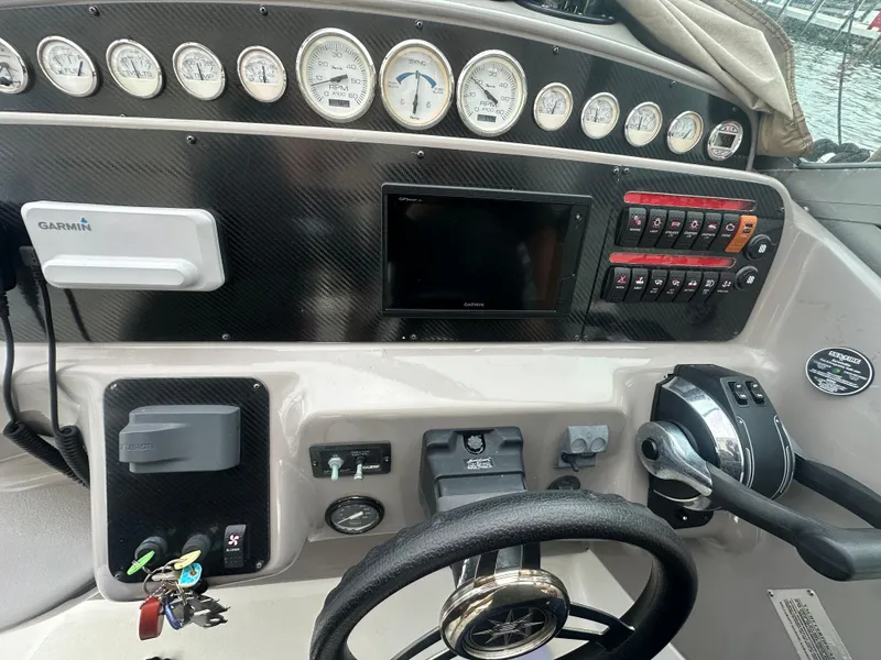 Slide: The Image of 2001 Wellcraft 3300 Martinique boat dashboard with gauges and controls. - 15