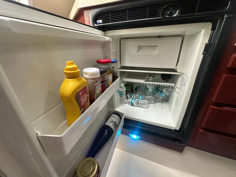 Slide: The Image of Open fridge in 2001 Wellcraft 3300 Martinique boat, stocked with condiments and drinks. - 16