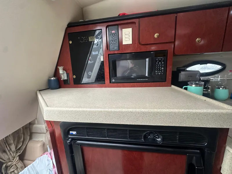 Slide: The Image of 2001 Wellcraft 3300 Martinique boat kitchen with microwave and cabinets. - 18