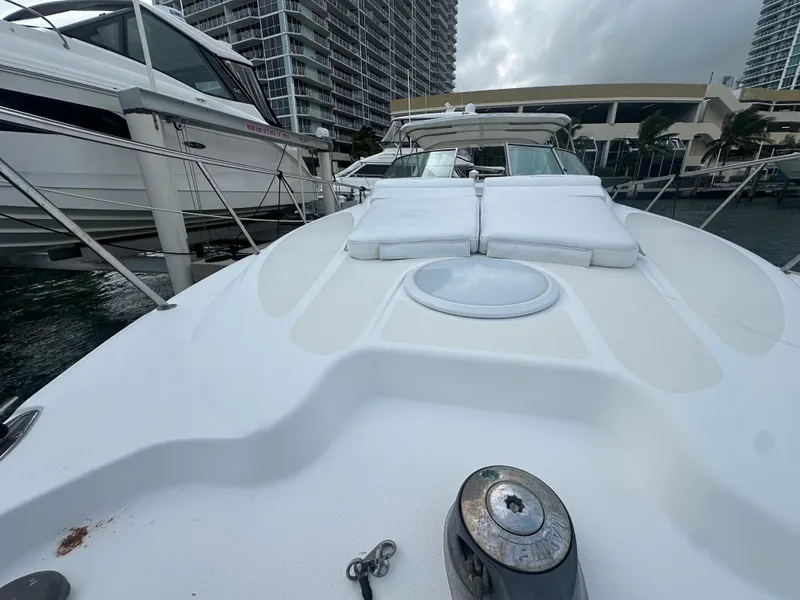 Slide: The Image of 2001 Wellcraft 3300 Martinique yacht docked at marina, featuring spacious deck and modern design. - 24