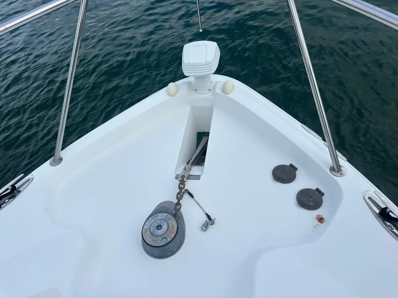 Slide: The Image of Bow of 2001 Wellcraft 3300 Martinique boat with anchor chain and calm water. - 25