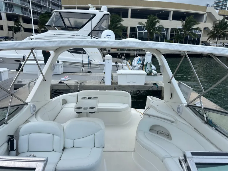 Slide: The Image of 2001 Wellcraft 3300 Martinique yacht with white seating at marina dock. - 26