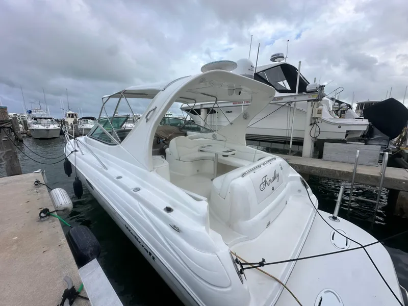 Slide: The Image of 2001 Wellcraft 3300 Martinique boat docked at marina under cloudy skies. - 3