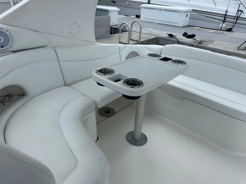 Slide: The Image of 2001 Wellcraft 3300 Martinique boat interior with white seating and table. - 5