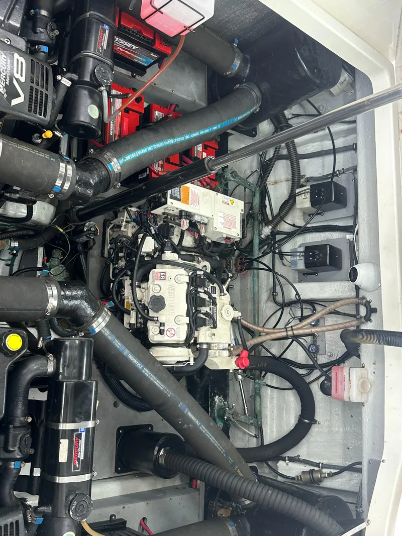 Slide: The Image of Engine compartment of 2001 Wellcraft 3300 Martinique boat, showcasing mechanical components and wiring. - 7