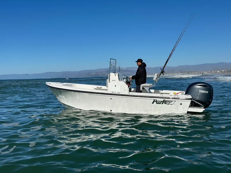 Slide: The Image of 2024 Parker 18SE Center Console boat on open water, clear sky background. - 2