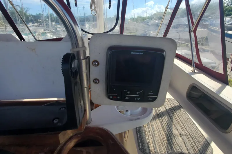 Slide: The Image of 1987 Irwin MKII sailboat cockpit with navigation equipment and steering wheel. - 13