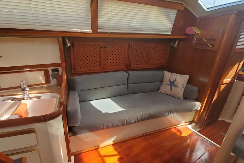 Slide: The Image of 1987 Irwin MKII yacht interior with sofa, sink, and wooden cabinetry. - 18