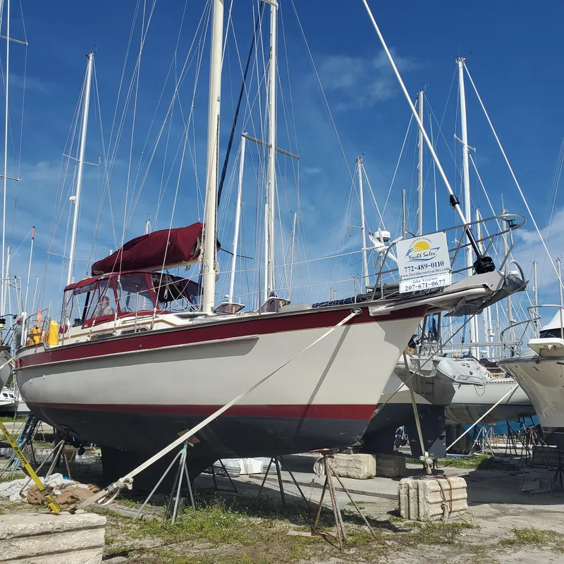 Slide: The Image of 1987 Irwin MKII sailboat on stands in a marina, clear blue sky background. - 2