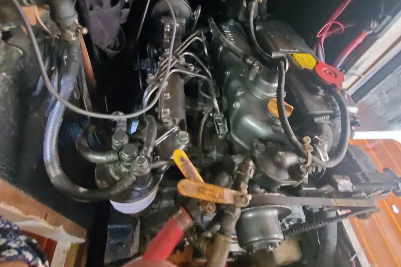 Slide: The Image of Engine compartment of a 1987 Irwin MKII, showcasing mechanical components and wiring. - 34