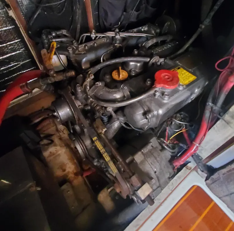 Slide: The Image of 1987 Irwin MKII engine with visible components and wiring in a boat compartment. - 35