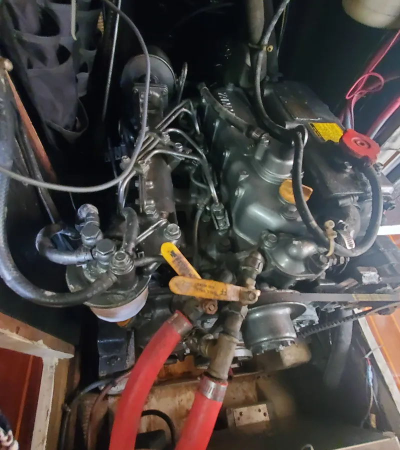 Slide: The Image of Engine compartment of a 1987 Irwin MKII sailboat, showcasing mechanical components and hoses. - 36