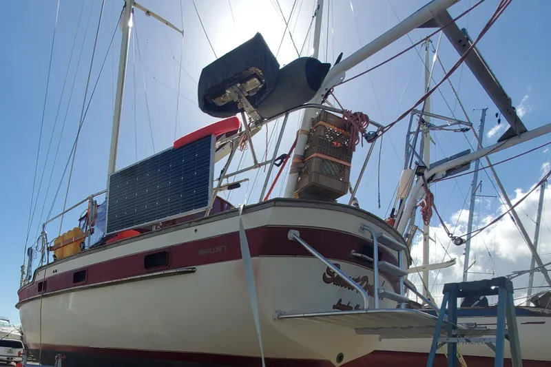 Slide: The Image of 1987 Irwin MKII sailboat with solar panel, docked under clear sky. - 5