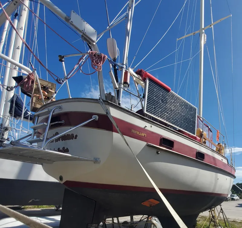 Slide: The Image of 1987 Irwin MKII sailboat on land, blue sky background. - 8