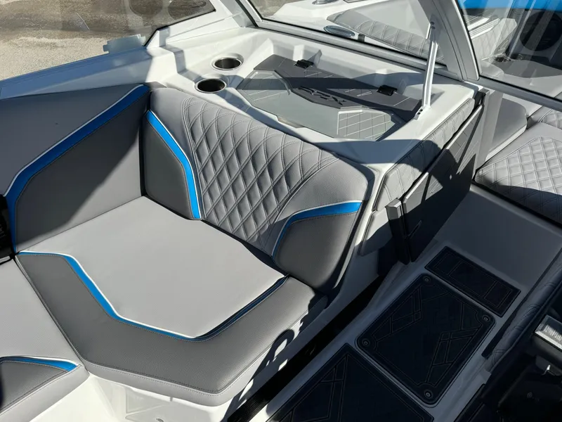 Slide: The Image of 2025 Tigé 24RZX boat interior with gray and blue seating, cup holders, and modern design. - 12