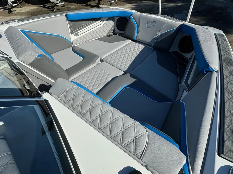 Slide: The Image of 2025 Tigé 24RZX boat interior with gray and blue quilted seating. - 14