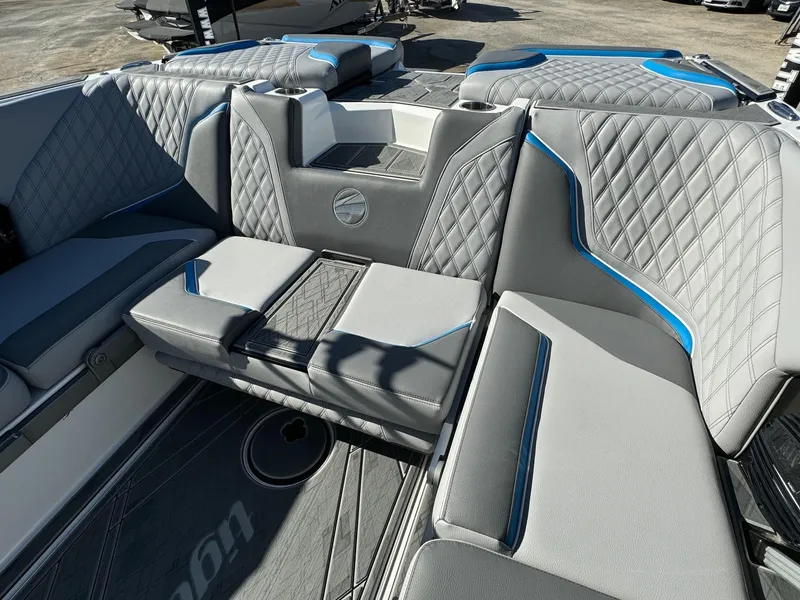 Slide: The Image of 2025 Tigé 24RZX boat interior with gray and blue diamond-stitched seating. - 8