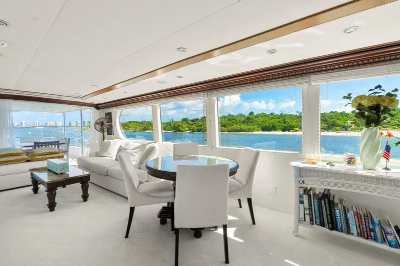 Slide: The Image of Luxurious interior of 1984 Broward 110 Motor Yacht with ocean view and elegant furnishings. - 10