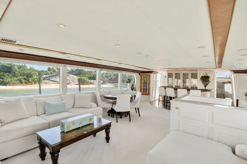 Slide: The Image of Luxurious interior of 1984 Broward 110 Motor Yacht with elegant seating and panoramic windows. - 12