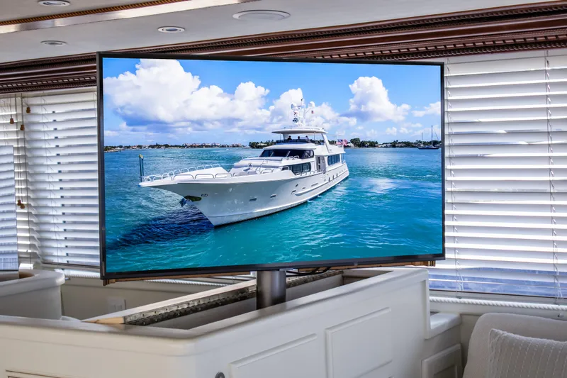 Slide: The Image of Broward 110 Motor Yacht 1984 displayed on a TV in a luxurious room. - 13