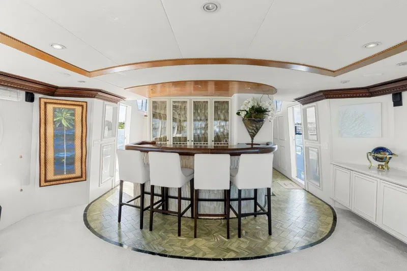 Slide: The Image of Luxurious interior of 1984 Broward 110 Motor Yacht with elegant bar and seating area. - 17