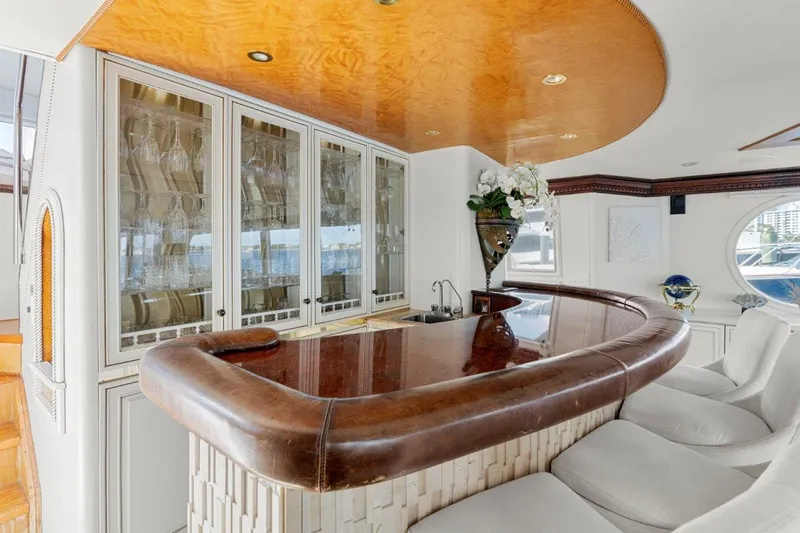 Slide: The Image of Luxurious bar area inside 1984 Broward 110 Motor Yacht with elegant seating and cabinetry. - 18