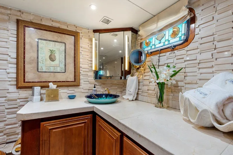 Slide: The Image of Luxurious bathroom on 1984 Broward 110 Motor Yacht with elegant decor and modern amenities. - 29