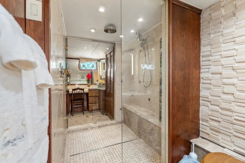 Slide: The Image of Luxurious bathroom in 1984 Broward 110 Motor Yacht with modern shower and elegant decor. - 30