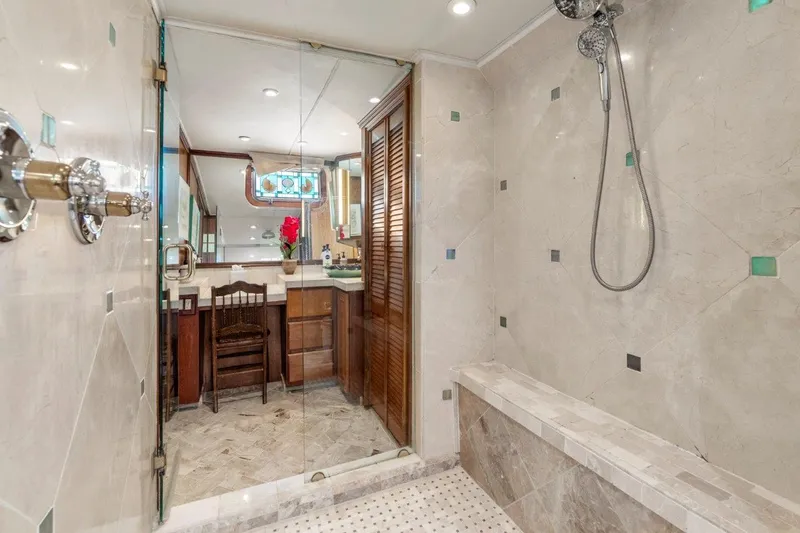 Slide: The Image of Luxurious bathroom in 1984 Broward 110 Motor Yacht with marble shower and elegant vanity. - 31