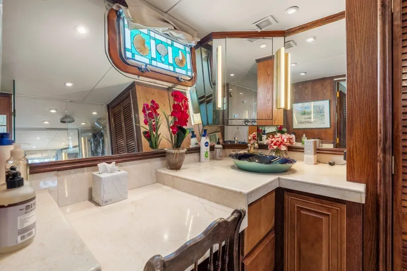 Slide: The Image of Luxurious 1984 Broward 110 Motor Yacht interior with elegant vanity and stained glass window. - 32