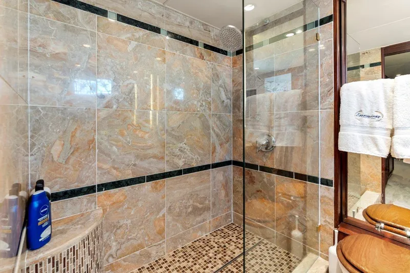 Slide: The Image of Luxurious bathroom with marble tiles in 1984 Broward 110 Motor Yacht. - 37