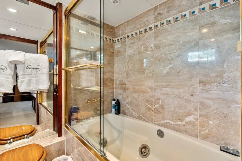Slide: The Image of Luxurious bathroom in 1984 Broward 110 Motor Yacht with marble tiles and glass shower. - 42
