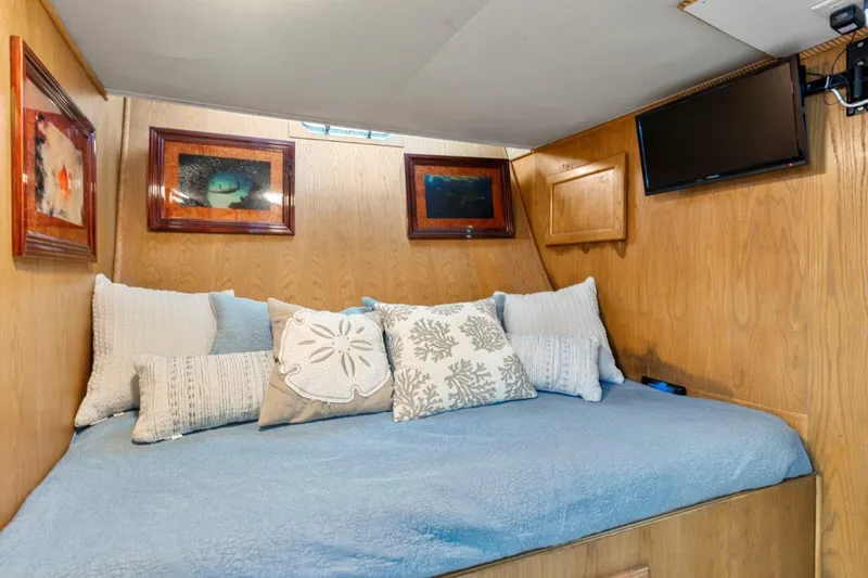 Slide: The Image of Cozy bedroom in 1984 Broward 110 Motor Yacht with blue bedding and decorative pillows. - 46