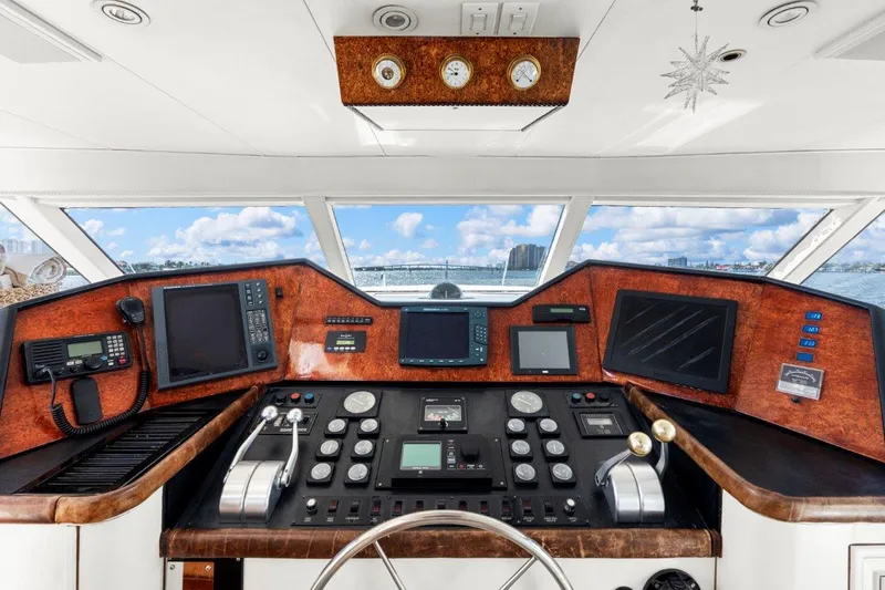 Slide: The Image of Control panel of a 1984 Broward 110 Motor Yacht with navigation instruments. - 49