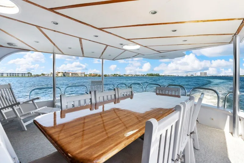 Slide: The Image of Spacious deck of 1984 Broward 110 Motor Yacht with ocean view and dining area. - 7