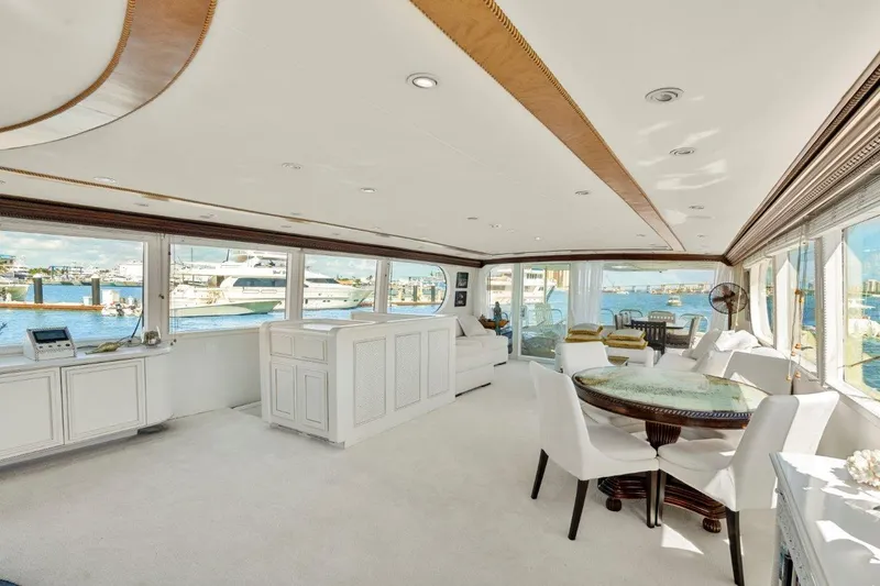 Slide: The Image of Luxurious interior of 1984 Broward 110 Motor Yacht with elegant furnishings and panoramic windows. - 9