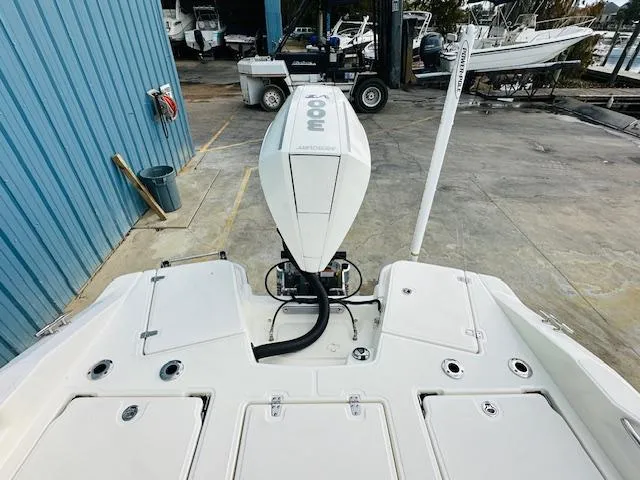 Slide: The Image of 2025 Boston Whaler 250 Dauntless boat with powerful outboard motor in marina setting. - 10