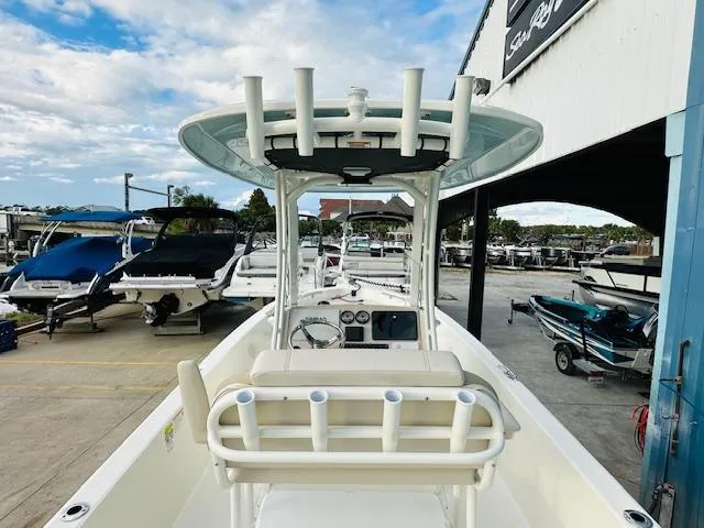 Slide: The Image of 2025 Boston Whaler 250 Dauntless boat at marina, featuring center console and rod holders. - 13
