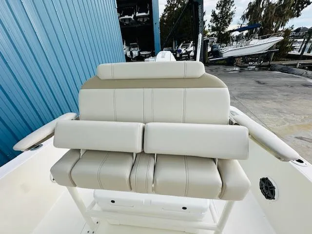 Slide: The Image of 2025 Boston Whaler 250 Dauntless boat seating, white leather, outdoor marina setting. - 18