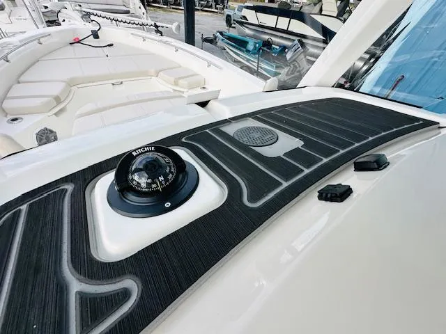Slide: The Image of 2025 Boston Whaler 250 Dauntless dashboard with compass and controls. - 20