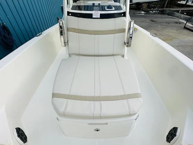 Slide: The Image of 2025 Boston Whaler 250 Dauntless boat interior with white cushioned seating. - 21