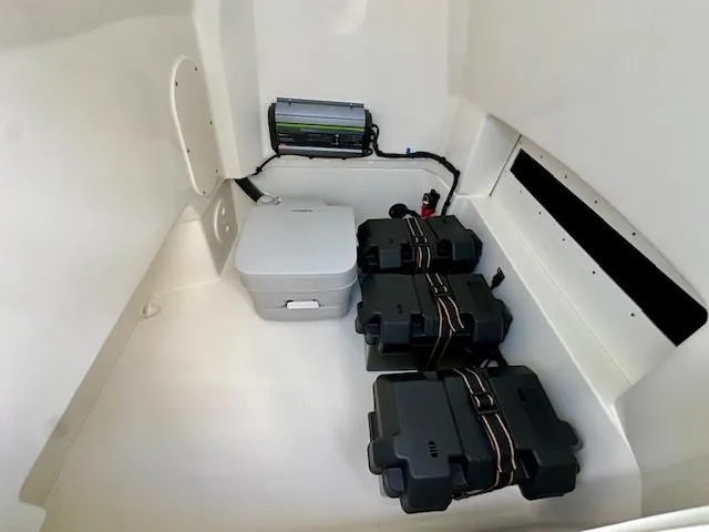 Slide: The Image of Interior of 2025 Boston Whaler 250 Dauntless boat with battery storage and equipment. - 23