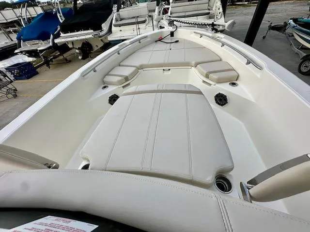 Slide: The Image of 2025 Boston Whaler 250 Dauntless boat interior with cushioned seating and storage compartments. - 24