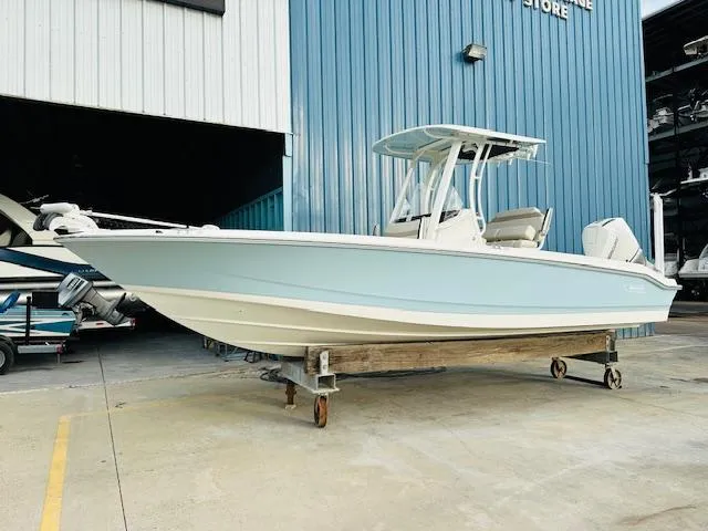 Slide: The Image of 2025 Boston Whaler 250 Dauntless boat in light blue, parked outside a storage facility. - 3
