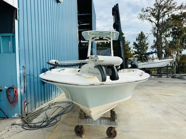 Slide: The Image of 2025 Boston Whaler 250 Dauntless boat docked near blue building. - 4