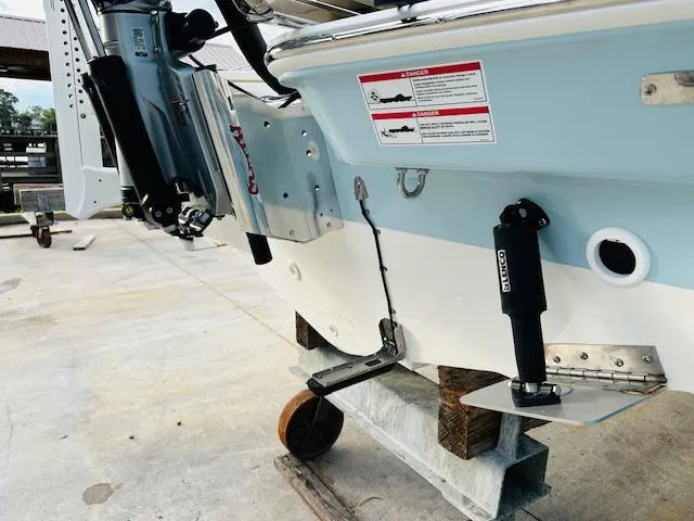 Slide: The Image of 2025 Boston Whaler 250 Dauntless boat stern with trim tabs and outboard motor. - 7